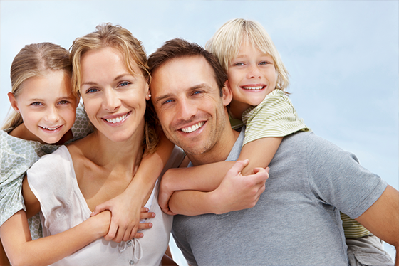 Family of Four Smiling All With Nice White Clean Teeth