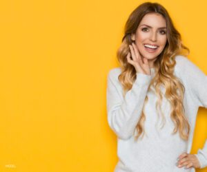 Model in White Sweater on Yellow Background